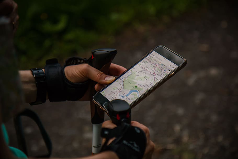 person using smartphone with nordic walking sticks, person holding black iPhone 7 displaying map application, HD wallpaper