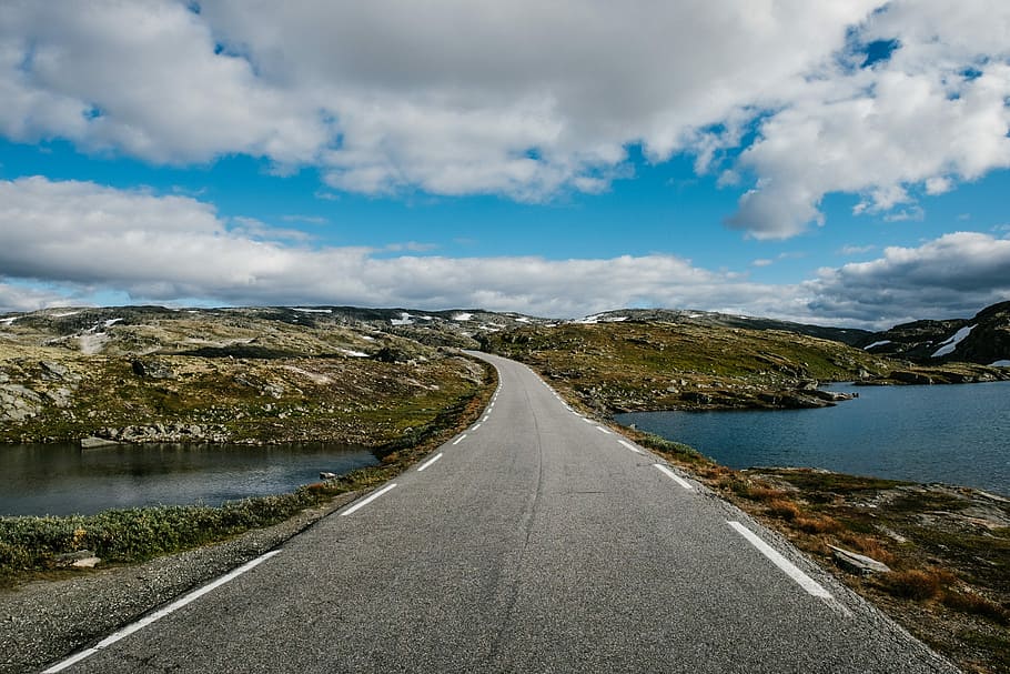 gray asphalt road under blue sky during daytime, road near hill under white clouds HD wallpaper