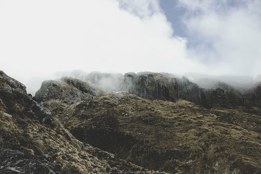 aerial photography of elevated mountain covered with clouds at daytime HD wallpaper