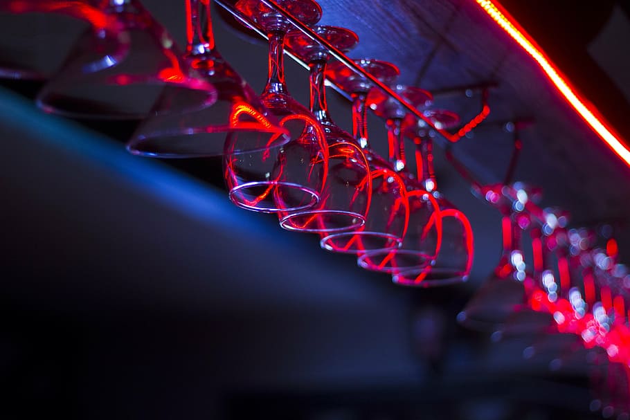 selective focus photo of champagne glasses hanging on rack HD wallpaper