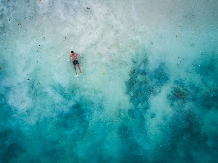 high-angle photography of man in body of water, aerial photo of man on body of water during daytime HD wallpaper