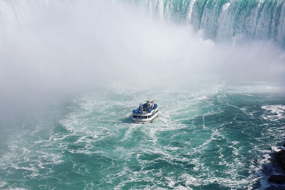 ship on body of water near falls, white and blue boat beside waterfall HD wallpaper