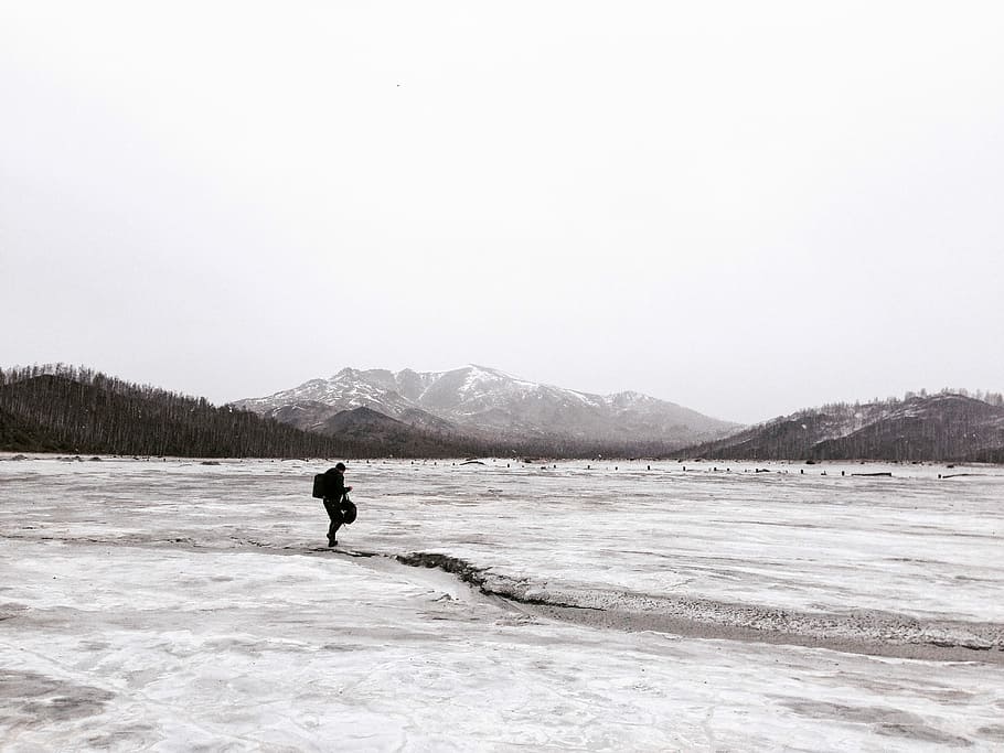 person walking on snow coated groudn, person standing on ground HD wallpaper