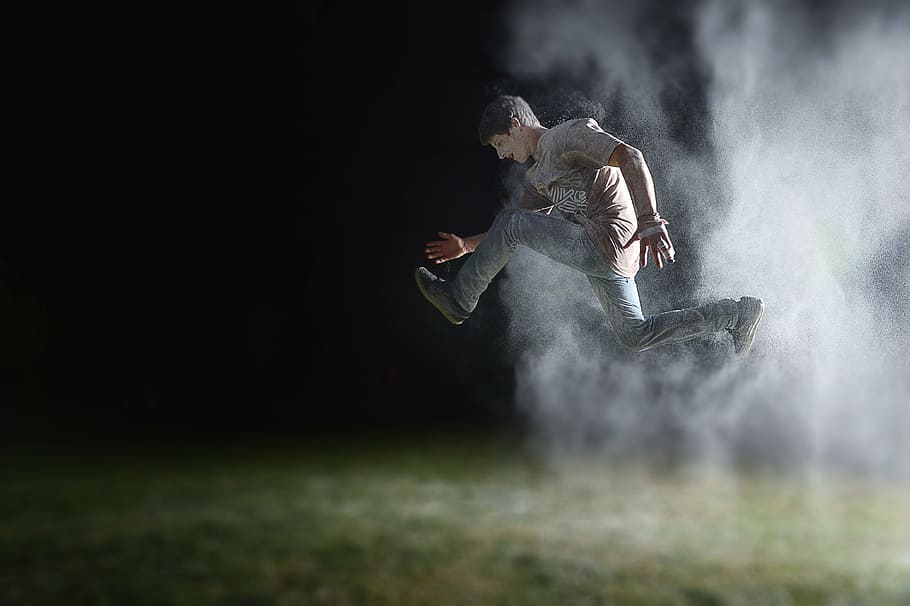 man in gray shirt jumping during night time, man jumping with smoke, HD wallpaper