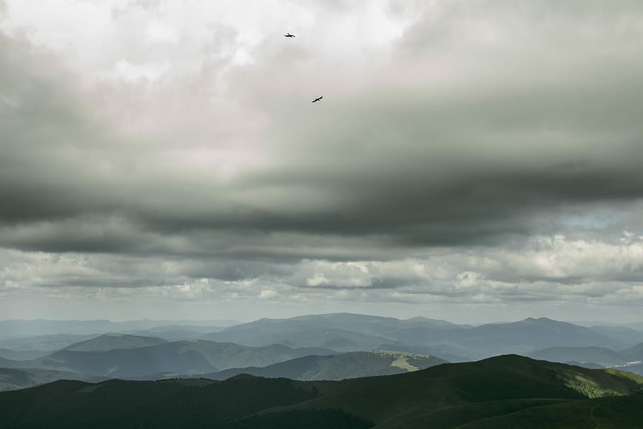 green hills under cloudy sky, aerial photography of mountain ranges HD wallpaper