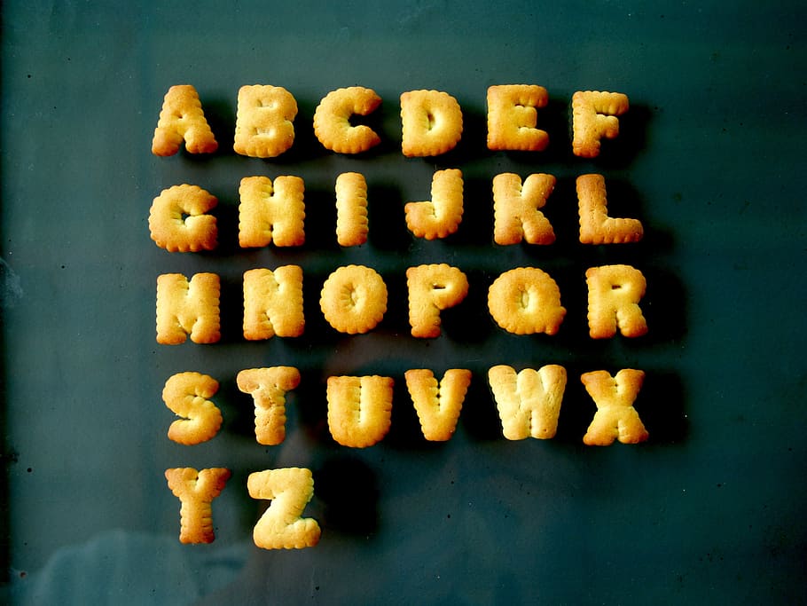 alphabet biscuits on top of clear glass surface, food, letter, HD wallpaper