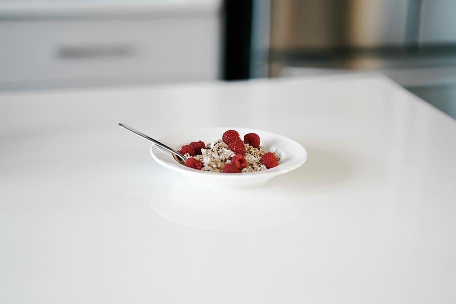 Bowl of cereal on kitchen counter, red raspberry on saucer, breakfast HD wallpaper