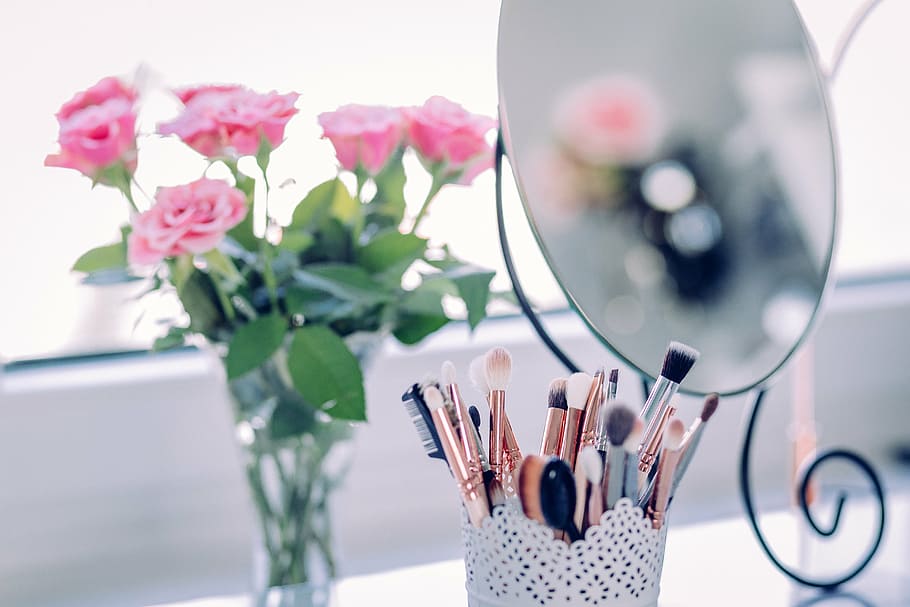 selective focus photography of pink rose in vase, makeup, brush HD wallpaper