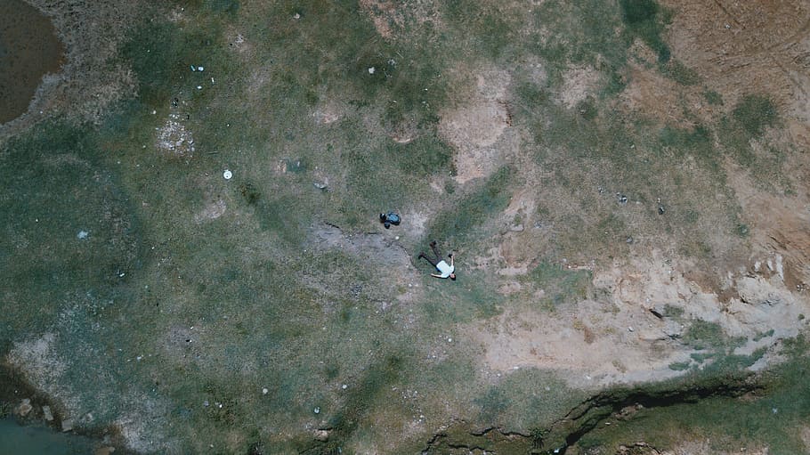 bird's eye-view photo of man lying on the floor, aerial photography of man lying on ground during day time HD wallpaper