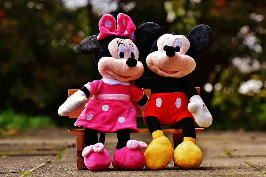 Minnie Mouse and Mickey Mouse sitting on bench plush toys, disney