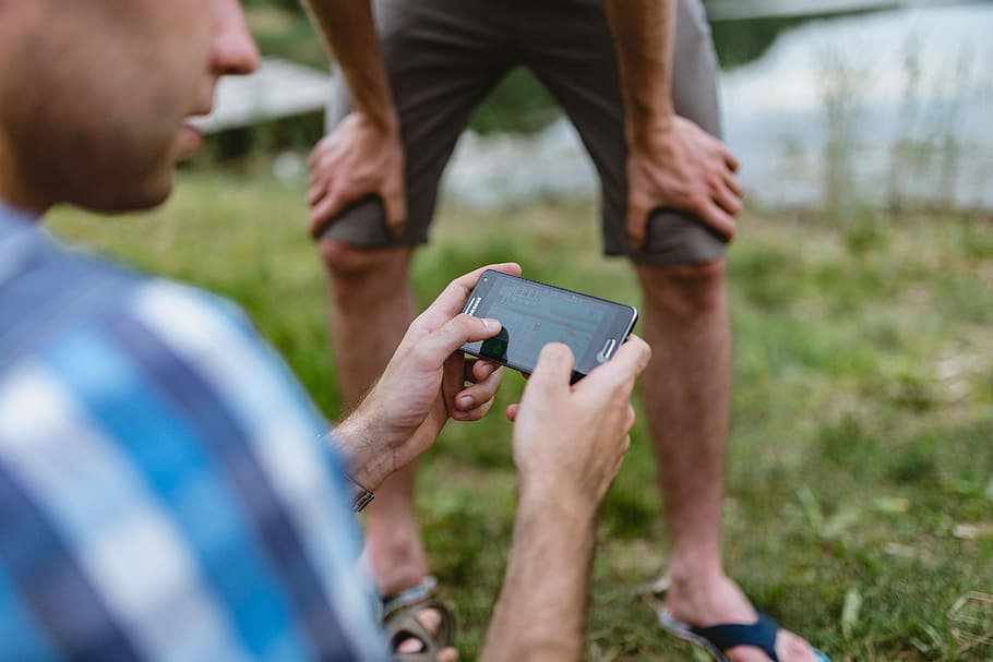 Closeup of man hands playing videogames on cell phone, technology HD wallpaper