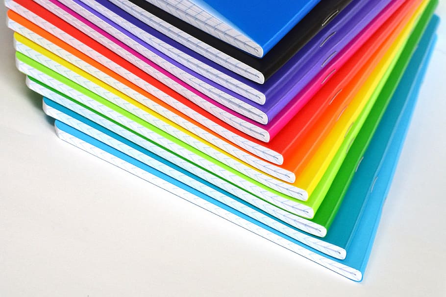 pile of book on white surface, notebooks, color, colored, rainbow HD wallpaper