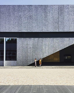 two person beside gray wall, three women standing beside gray concrete building HD wallpaper
