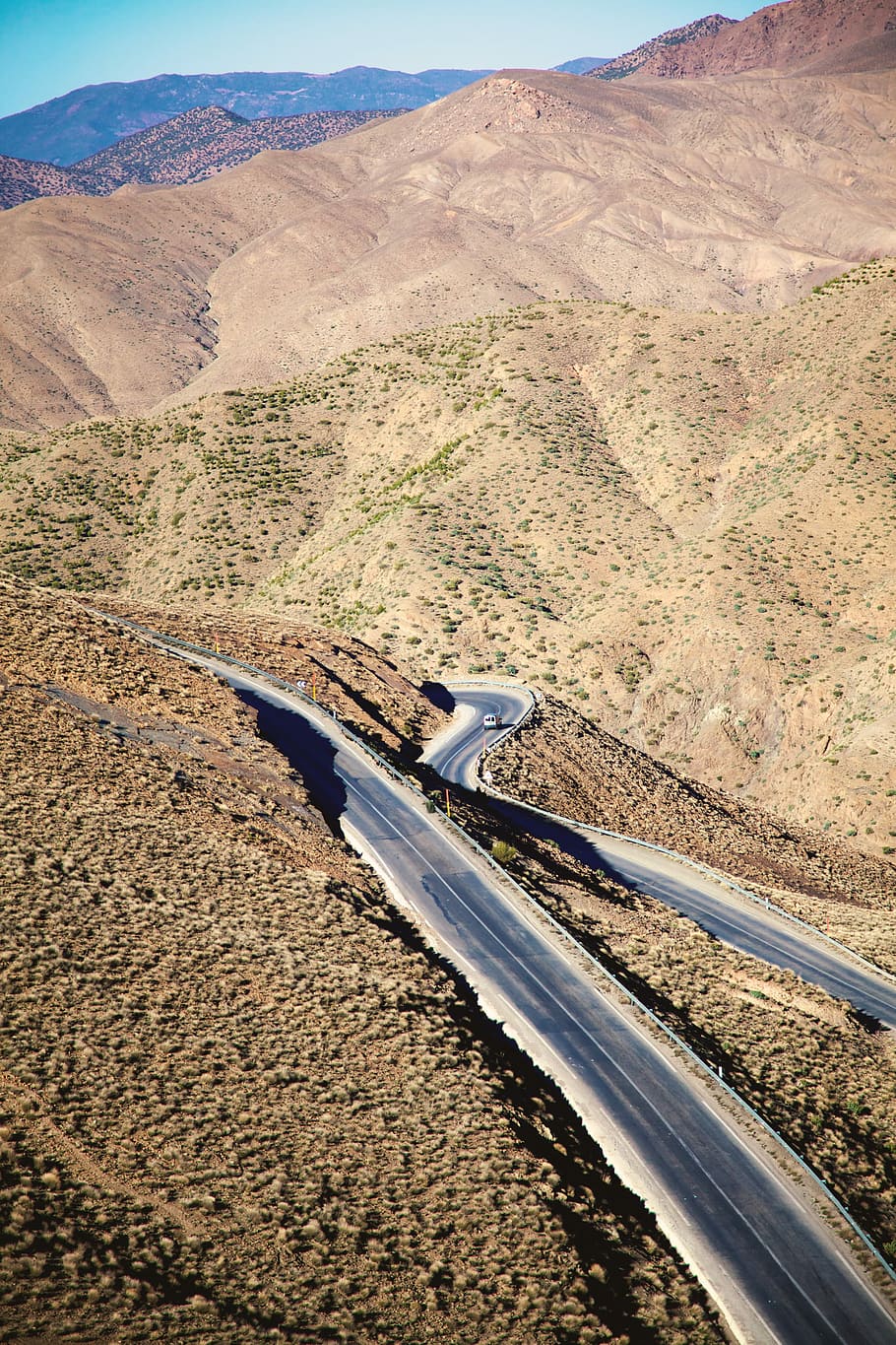 birds eye photography of road near mountains, aerial photo of gray road and brown mountains HD wallpaper