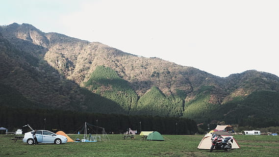 assorted-color dome tents near mountains under white clouds during daytime, white coupe and green tent on green field HD wallpaper