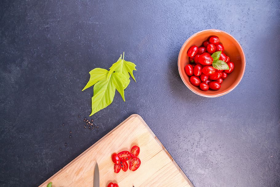 sliced tomatoes on brown wooden board near green herb, vegetables HD wallpaper