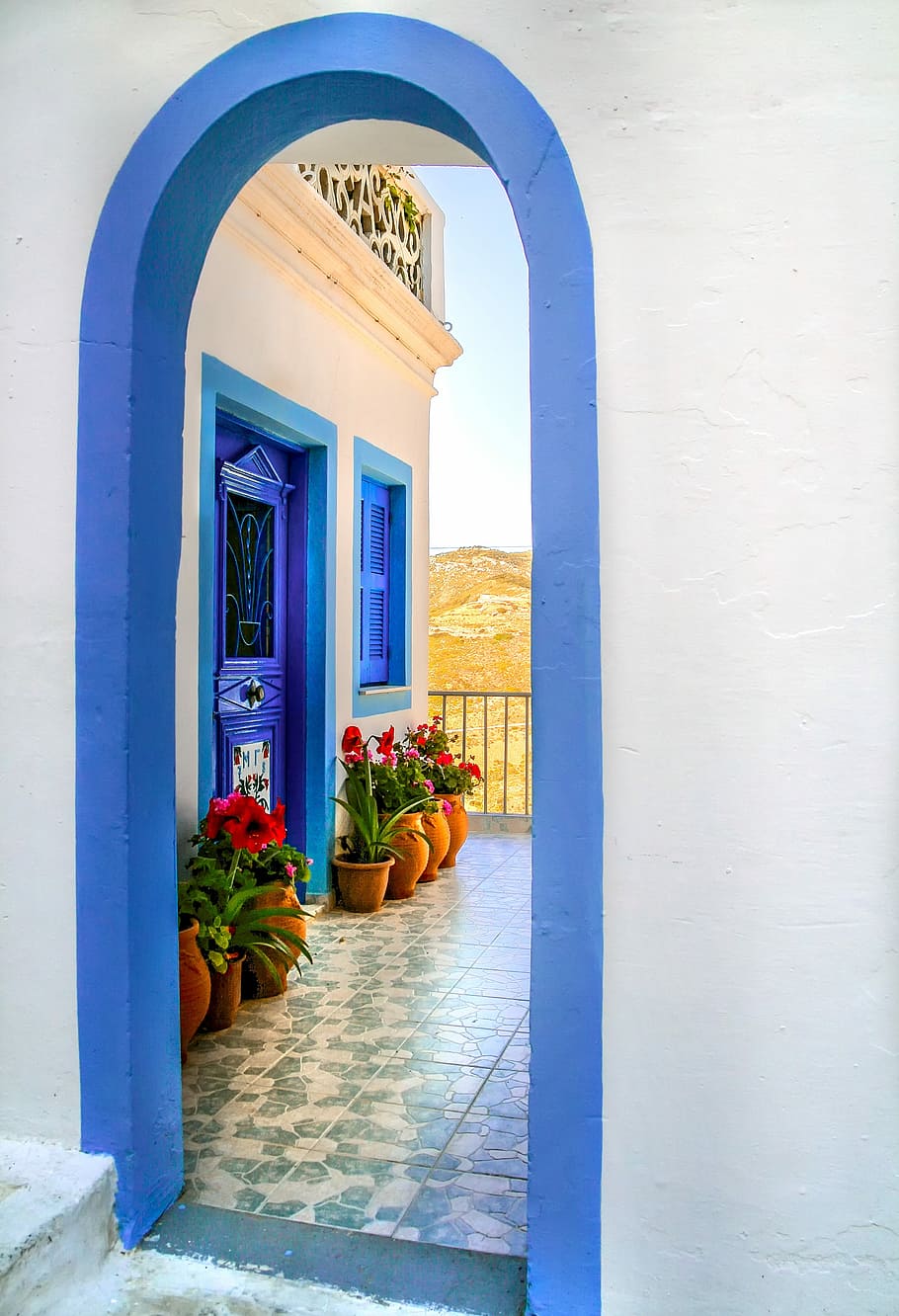 blue painted closed door with flower arrangement outside, architecture HD wallpaper
