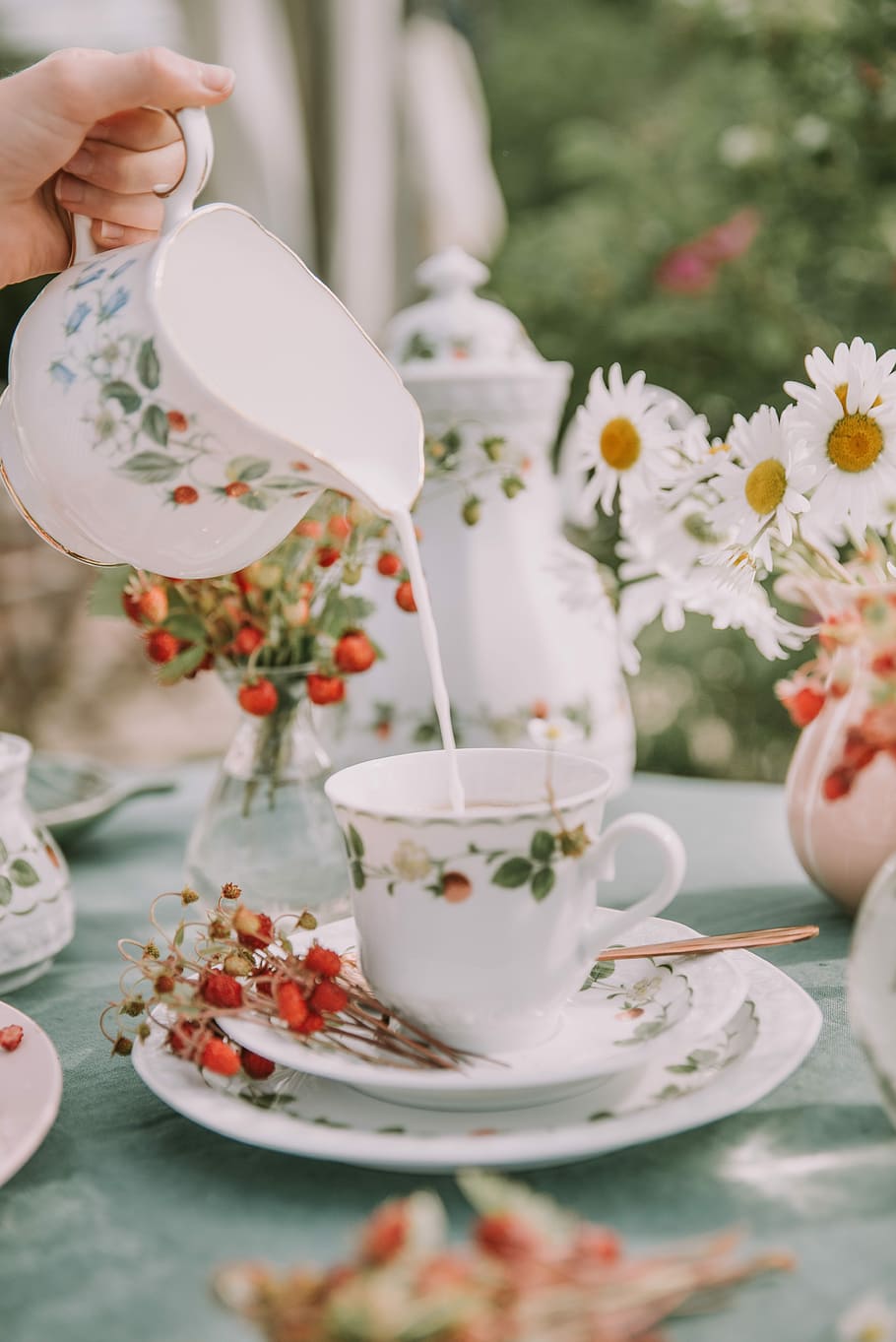 white ceramic mug and saucer on gray tablecloth, person pouring milk on teacup HD wallpaper