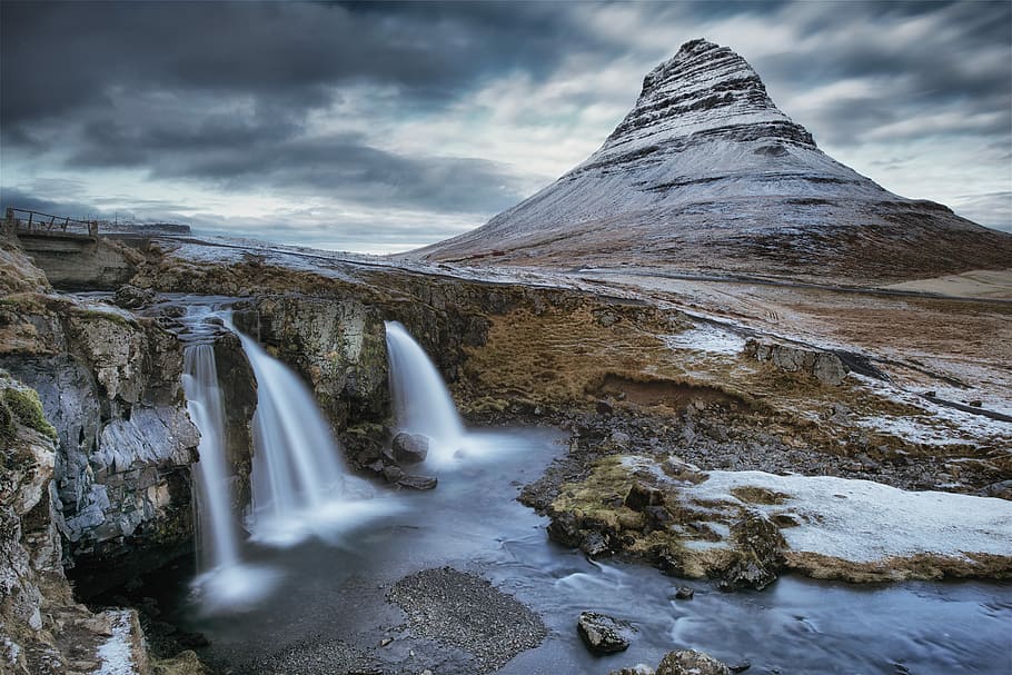 waterfalls near snowy mountain during daytime, long exposure photography of falls and mountain HD wallpaper