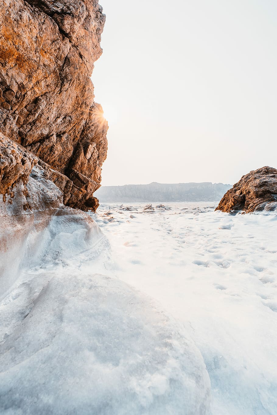 body of water beside rock formation, frozen body of water near mountain HD wallpaper