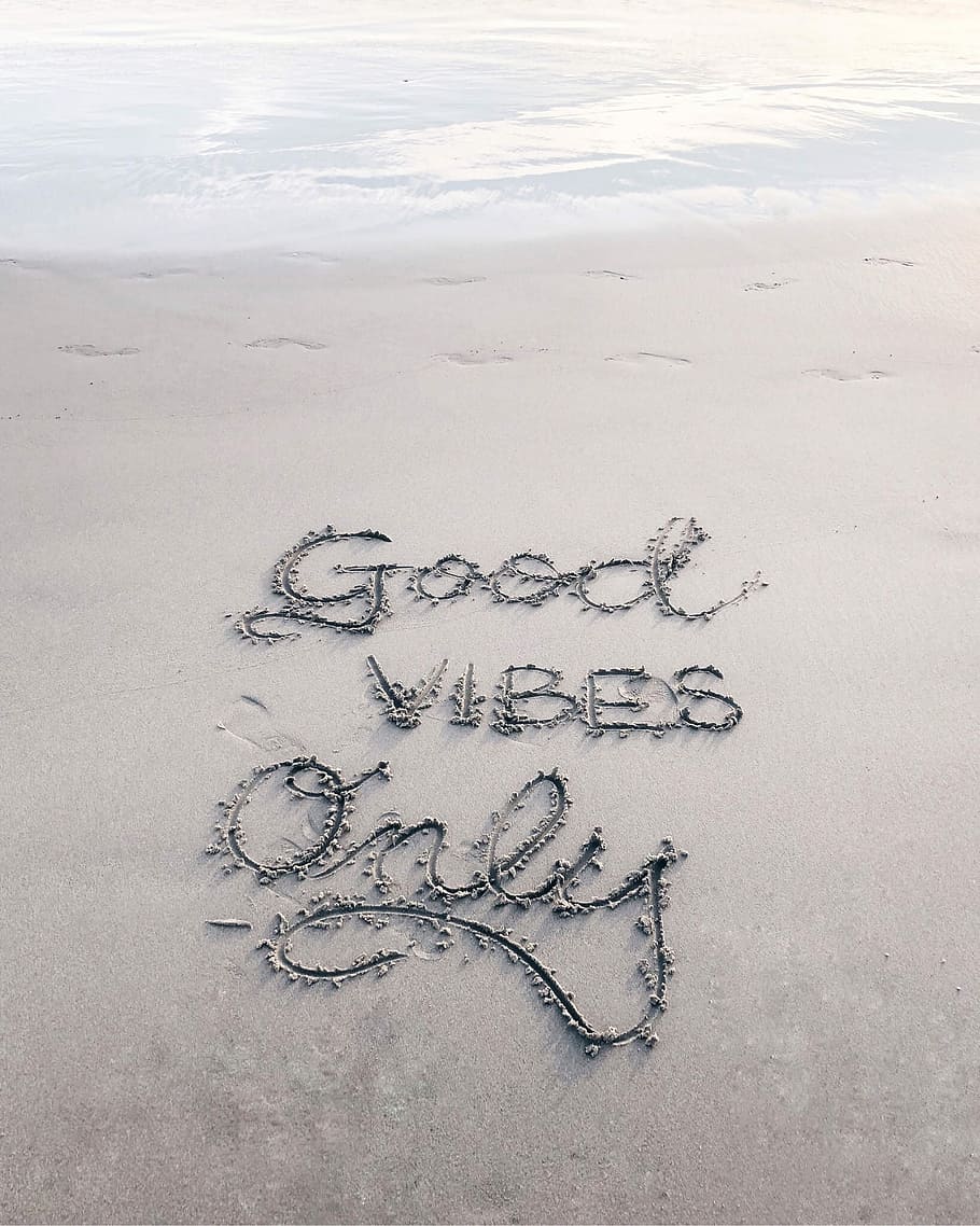 Good Vibes Only sand text, good vibes only written on the sand