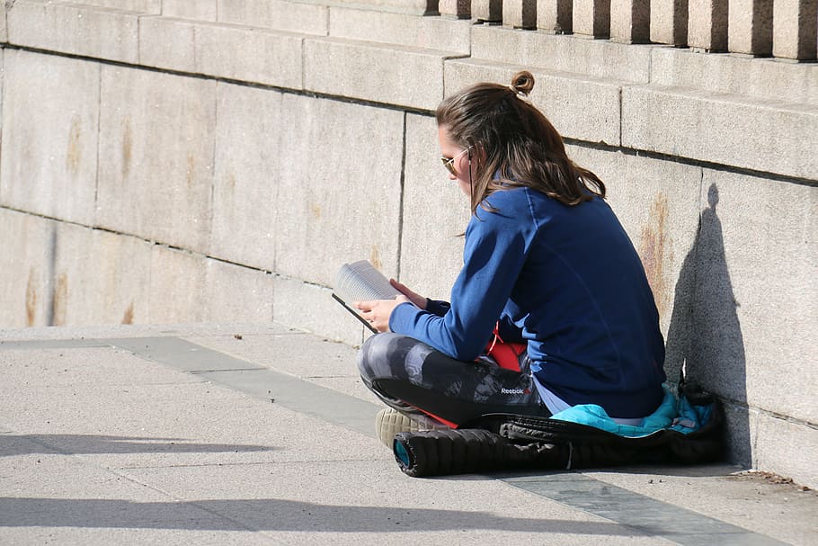 woman wearing blue denim jacket and black pants reading book HD wallpaper
