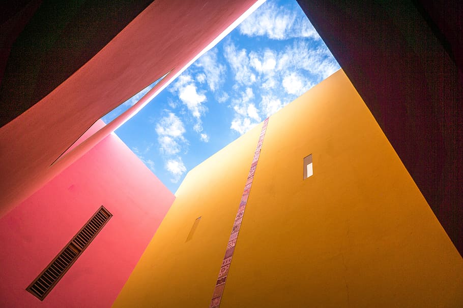 low-angle photo of yellow building, photo of orange painted wall, HD wallpaper