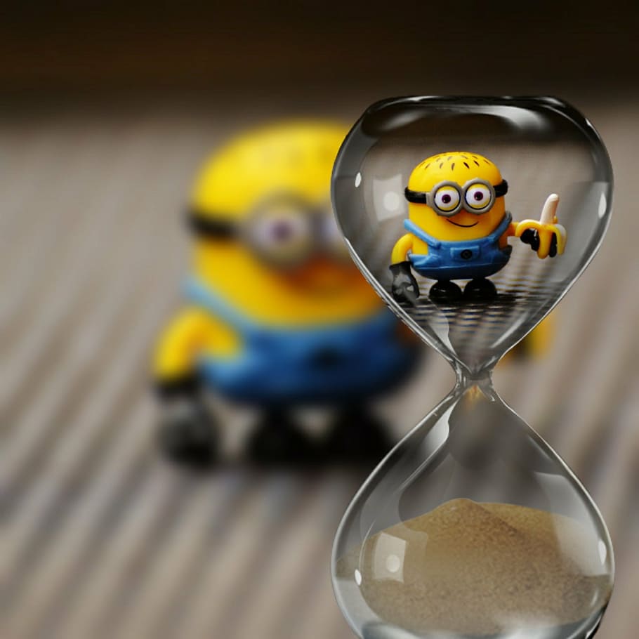 hourglass with minion action figure background, funny, toys, children