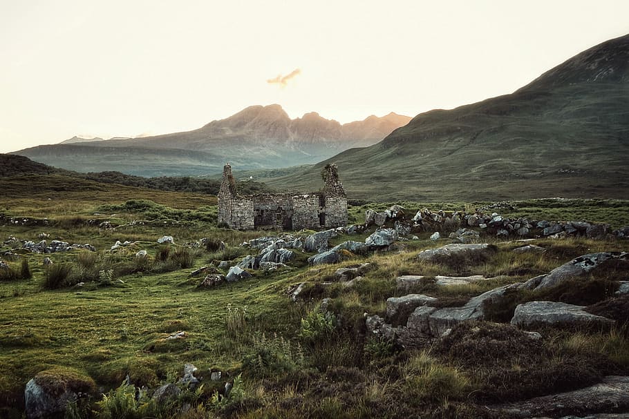 concrete ruins under white sky, rock formation in green open field with no people at daytime HD wallpaper