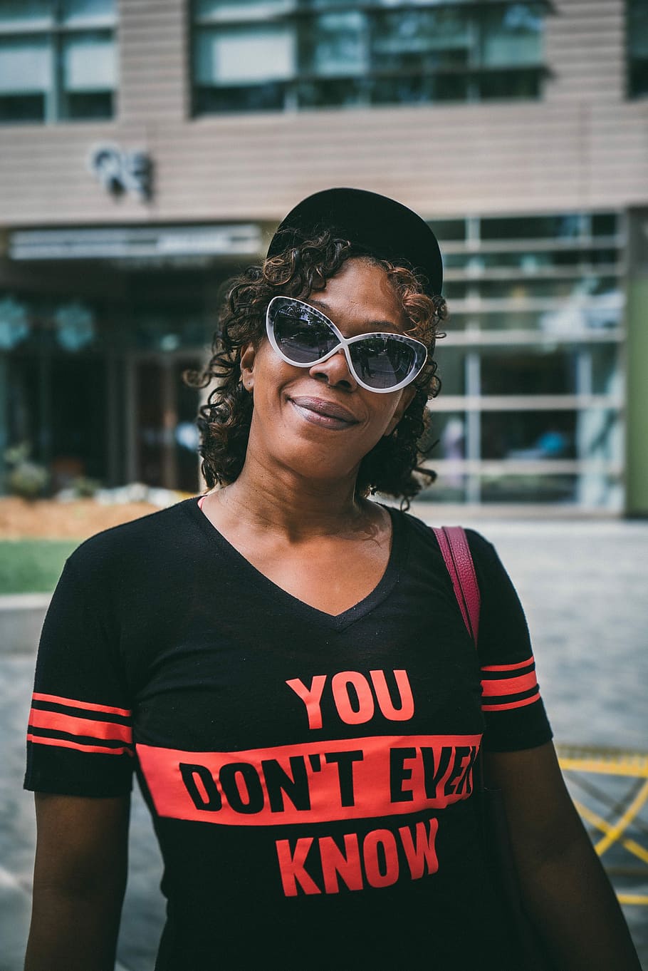 person wearing black crew-neck shirt with orange You Don't Ever Know text HD wallpaper