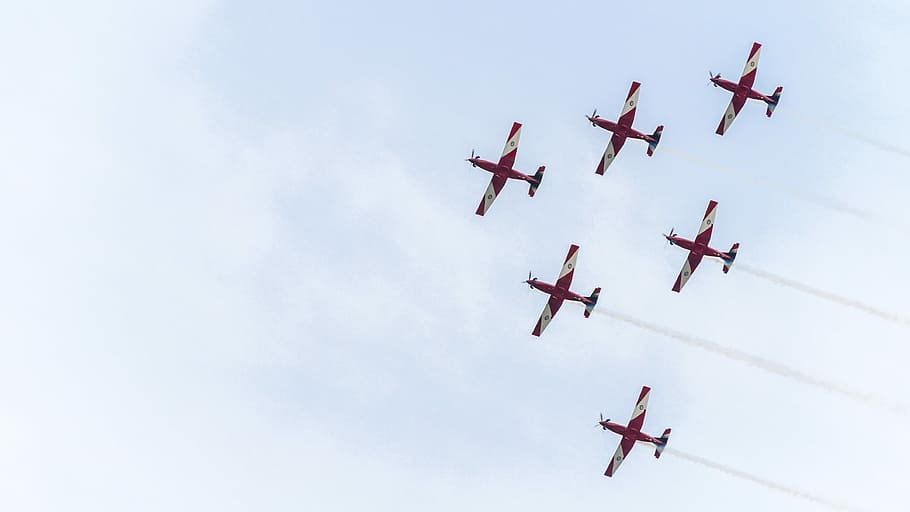 six red planes under white sky during daytime, red and white jet trail at daytime HD wallpaper