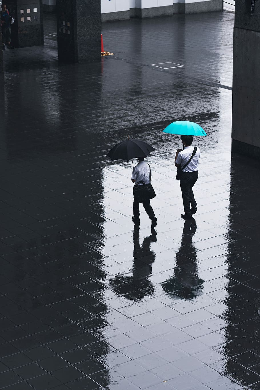 two men walking on road holding umbrellas during rainy time, two person holding teal and black umbrellas during rainyday, HD wallpaper