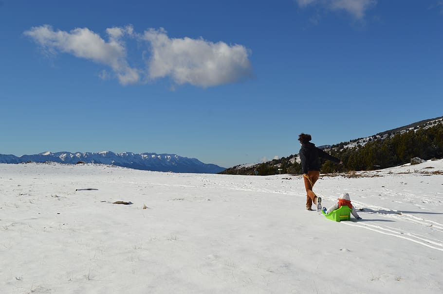person holding brown rope walking on snow field during daytime HD wallpaper