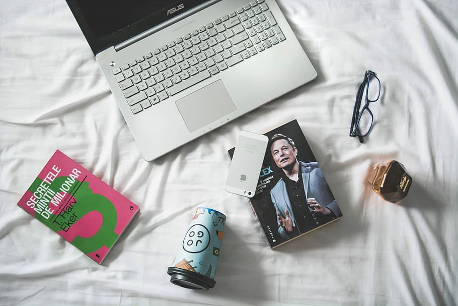 flat lay photography of MacBook and book with eyeglasses, silver iPhone 5s on Elon Musk book beside eyeglasses and Asus laptop, HD wallpaper