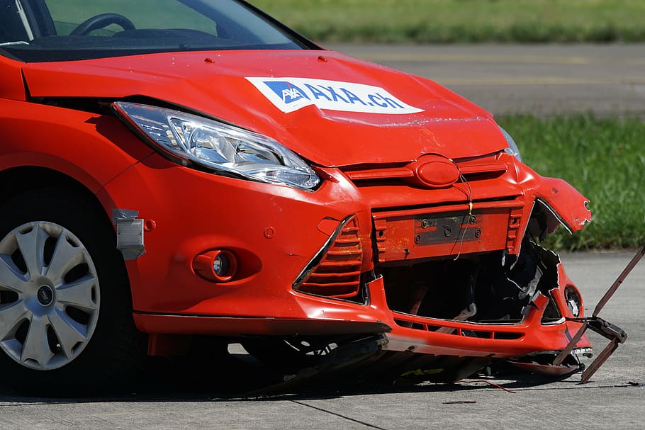 wrecked red Ford Focus car, crash test, collision, 60 km h, distraction