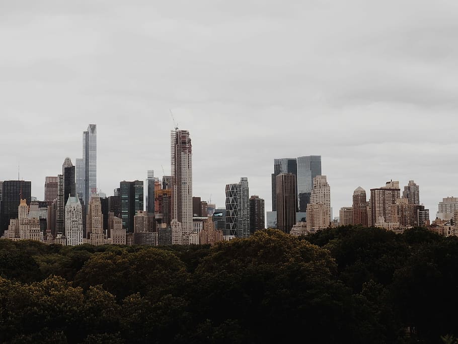 grey and brown building under grey sky, high-rise building under nimbus clouds HD wallpaper