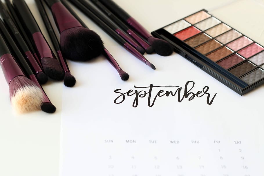 black-and-maroon makeup brush lot, white calendar poster with makeup brushes and eyeshadow palette, HD wallpaper