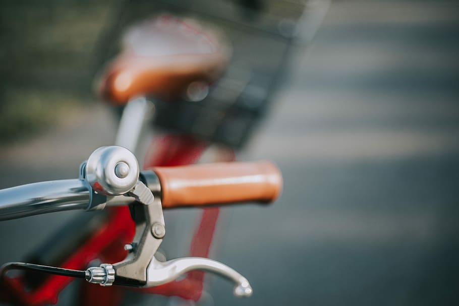 shallow focus photography of bicycle brake lever, macro photography of a red bike HD wallpaper