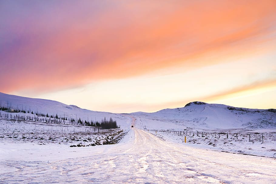 snow covered field during golden hour, snow-covered pathway under orange sky HD wallpaper