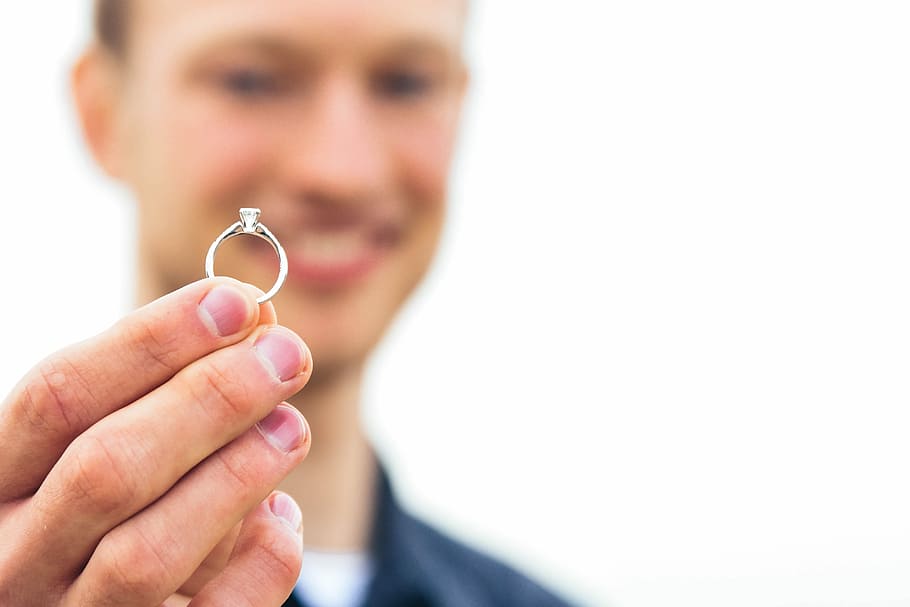 person holding silver-colored clear gemstone encrusted ring, selective focus photography of man holding silver-colored ring, HD wallpaper