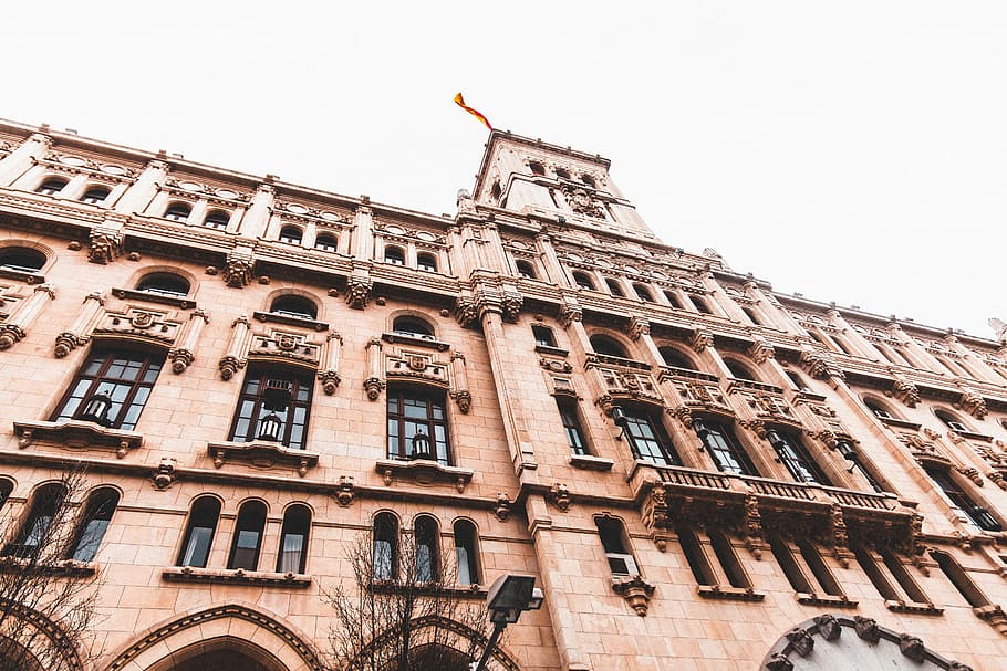 Lost in Madrid, low-angle photography of brown stone building HD wallpaper