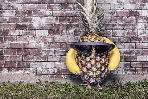 pineapple wearing sunglasses standing beside wall, whimsical HD wallpaper