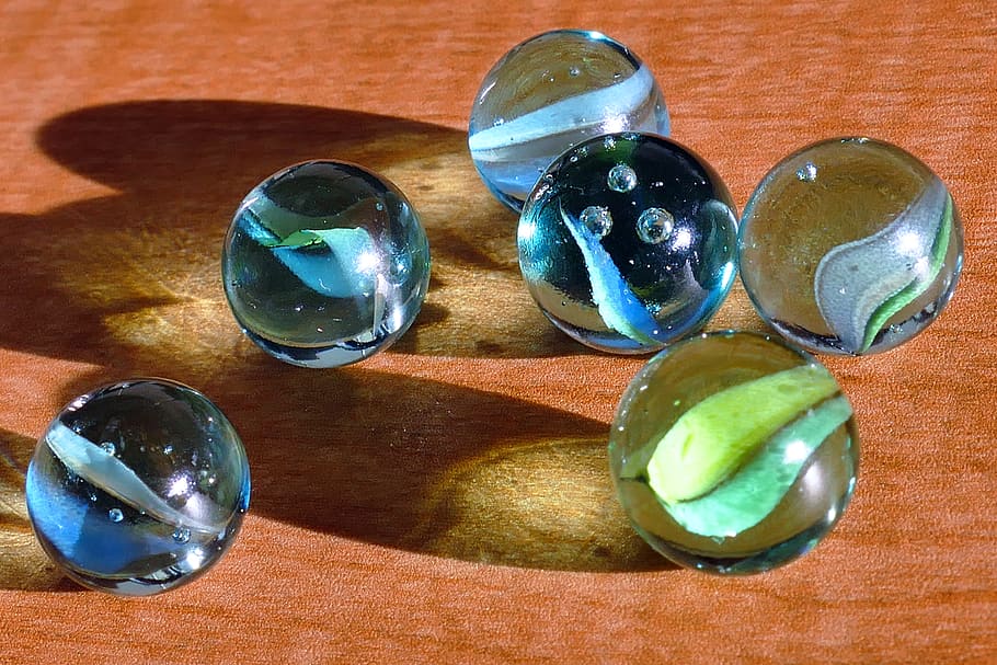 close-up photo of six marble balls, marbles, glass, toys, games