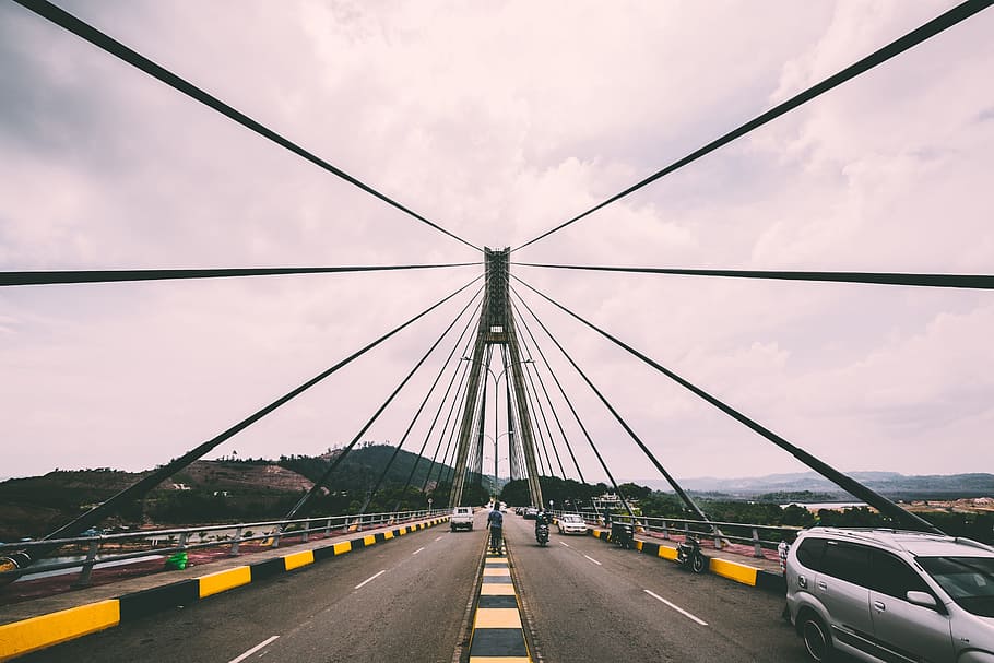 vehicles passing on gray suspension bridge at daytime, driving HD wallpaper
