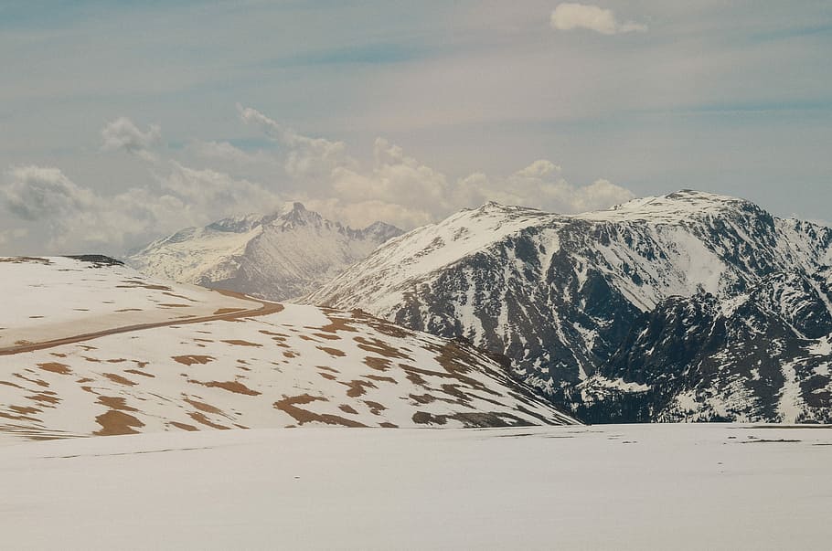 mountain alps under cumulus clouds, snow covered mountain under cloudy sky HD wallpaper