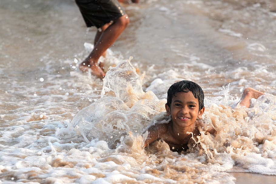 boy lying on shore taken during daytime, beach, waves, sea HD wallpaper
