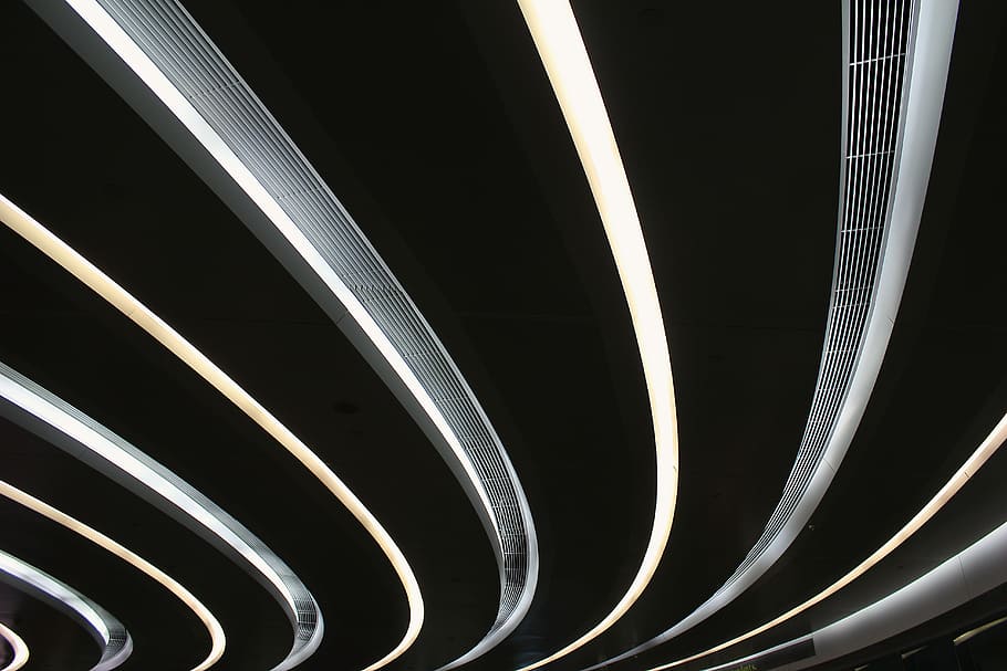 black and white tunnel, ceiling with turned on recessed lights