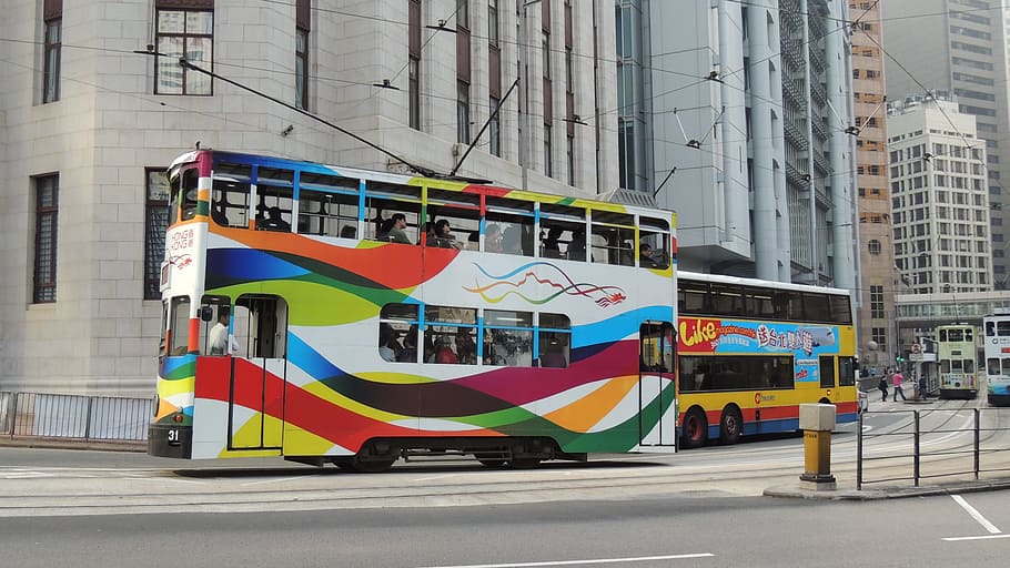 white, red, and yellow double-decker bus on road, hongkong, train