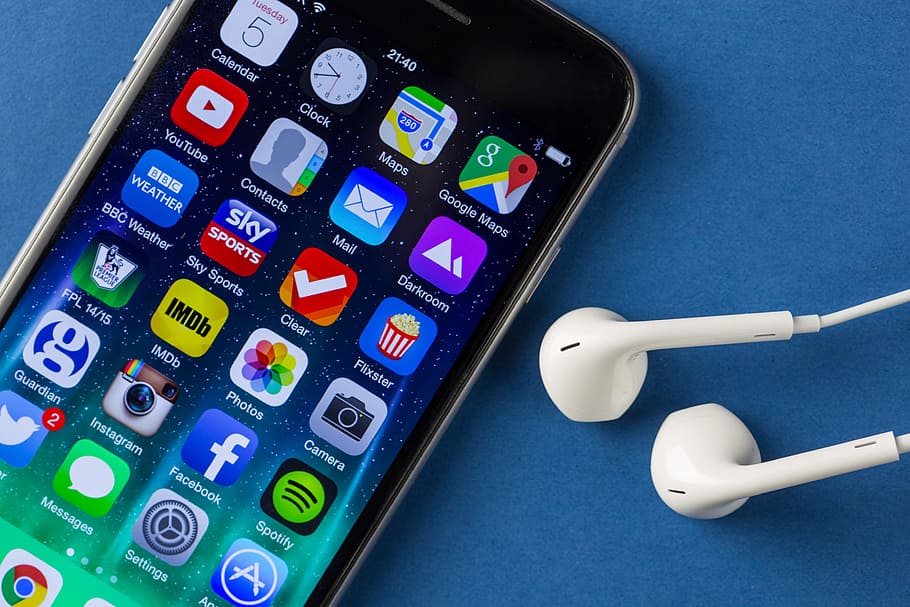 Close-up shot of the iPhone 6 mobile smartphone and earphones on a plain blue background, HD wallpaper
