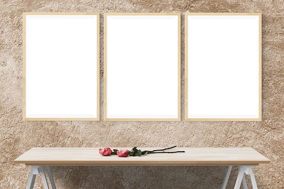 two red roses on rectangular brown wooden trestle table, poster